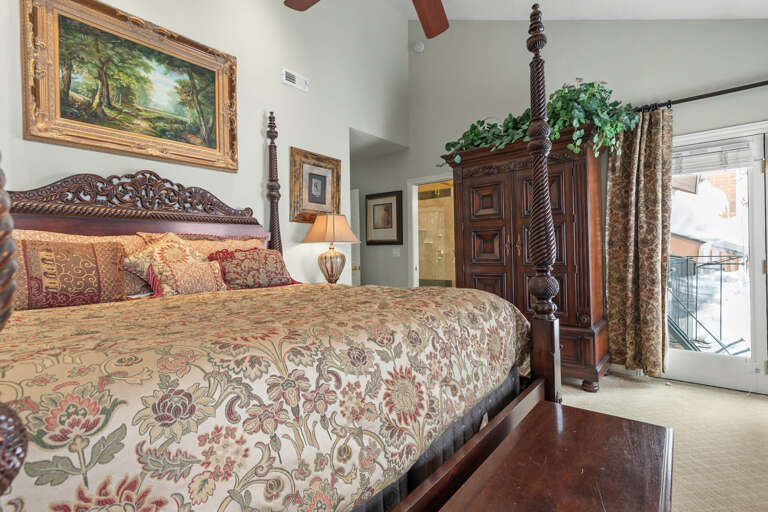Master Bedroom: "Serene retreat with king bed, cabinet, window view, fan, and artwork."