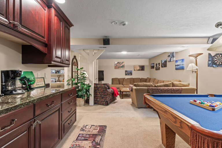 Unwind in your spacious entertainment room with a pool table, cozy sectional, and well-equipped kitchenette for all your snacks and refreshments.