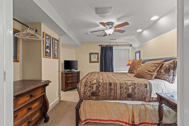 Your cozy retreat features a plush bed, warm Southwestern-style linens, classic wood furnishings, and convenient closet space—perfect for unwinding after a day of adventure.