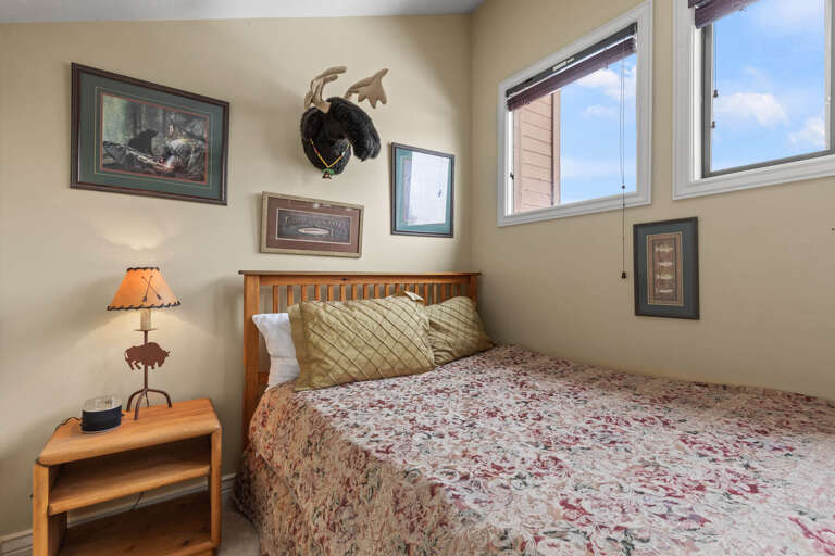 Unwind in your cozy bedroom, where rustic charm meets mountain comfort. Wake to natural light streaming through generous windows and feel at home with thoughtful touches all around.