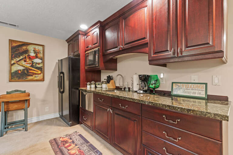 Your fully-equipped kitchen features rich cherry cabinetry, granite countertops, and modern appliances—everything you need to feel right at home while you're away.