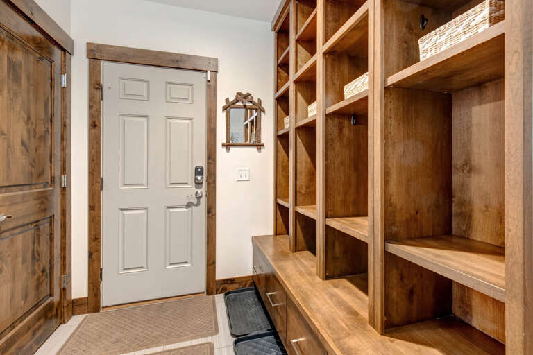 Step inside to find a welcoming entryway with custom-built wooden cubbies, perfect for organizing your gear and settling in after a day of adventure.