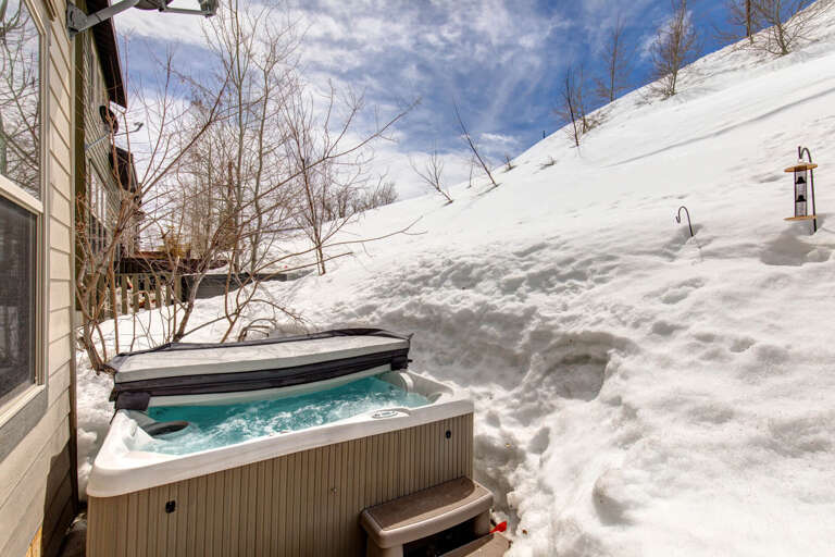 Nestled in pristine winter surroundings, your private hot tub invites you to unwind while soaking in stunning mountain vistas and fresh alpine air.