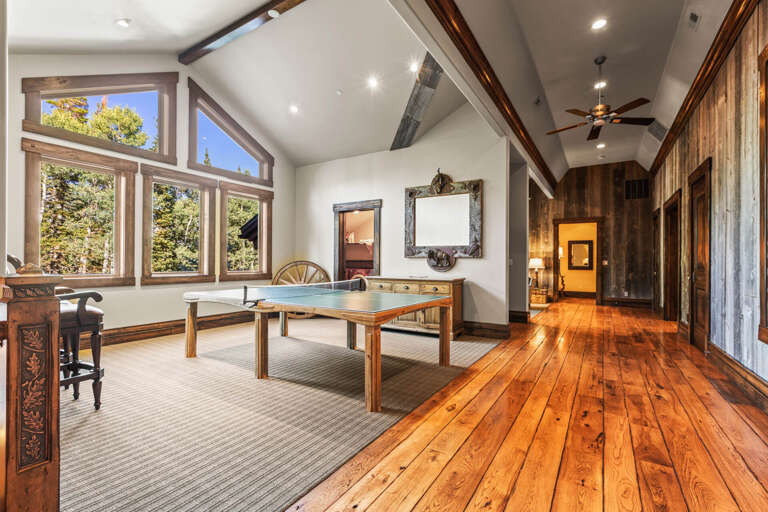 Table tennis by the windows, inviting a friendly competition.