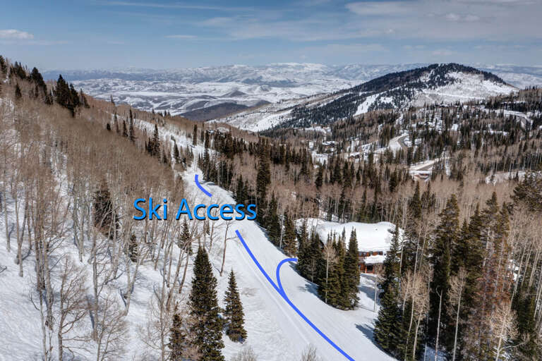 Mountain retreat nestled in snowy terrain offering direct ski slope access to pristine winter wilderness and breathtaking alpine vistas.