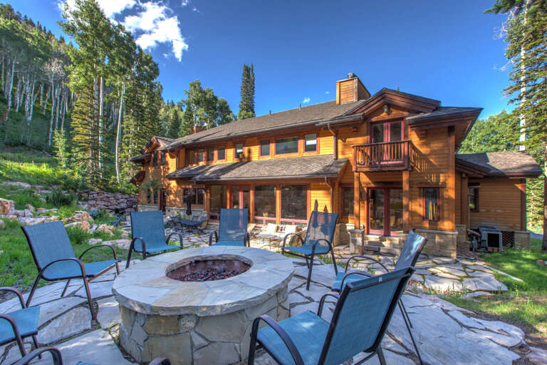 This mountain retreat sits nestled in aspen groves, featuring stone patio, fire pit, and access to scenic forest trails nearby.