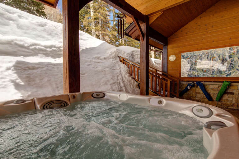 Slip into your private hot tub and let warm bubbles melt away tension while you soak in breathtaking winter mountain views and crisp alpine air.