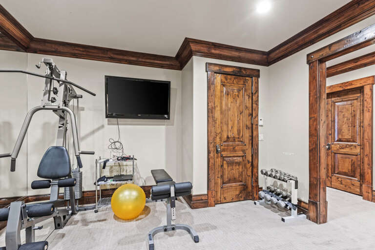 Your private fitness area features a multi-station weight machine, free weights, and exercise bench—everything you need for a satisfying workout during your stay.