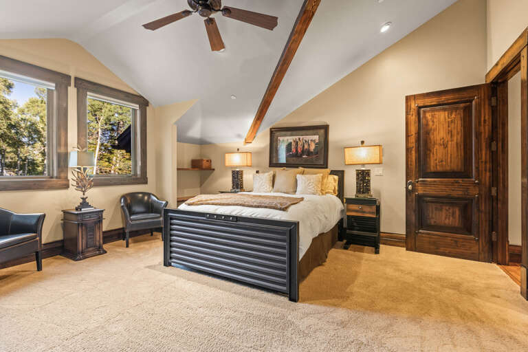 Step into your serene bedroom retreat, where vaulted ceilings, warm wood accents, and soft natural light invite restful sleep. Sink into the plush bed and enjoy peaceful garden views from your window.