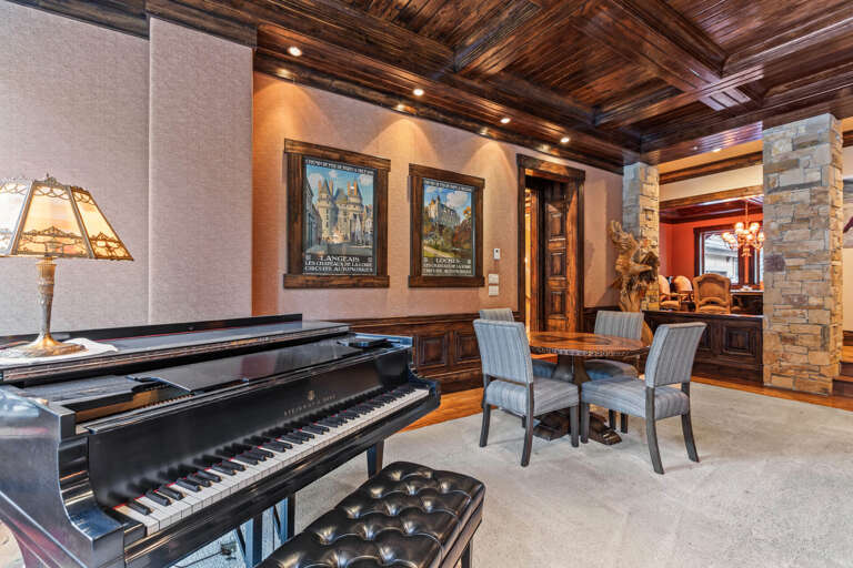 Step inside this stunning living space where rich wood ceilings and elegant furnishings create a sophisticated mountain retreat, perfect for your memorable stay.