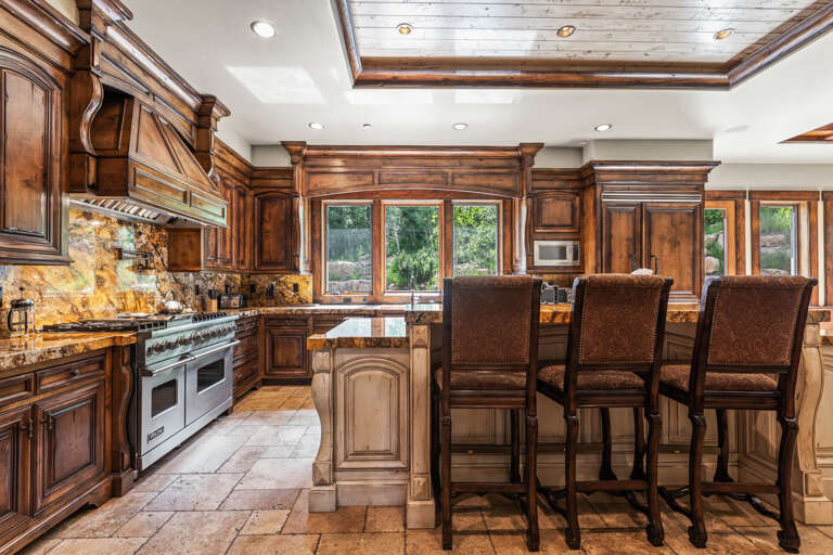 Step into a gourmet kitchen where rustic elegance meets modern convenience—rich wood cabinetry, granite counters, and a spacious island await your culinary adventures.