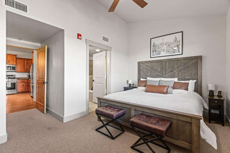 Sink into your plush bed after a day of mountain adventures, with rustic wood finishes and a cozy bench perfect for morning coffee as you plan the day ahead.