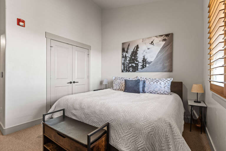 Your serene mountain retreat awaits, with crisp linens on a plush bed and soft lighting creating the perfect atmosphere for restful nights after adventurous days.
