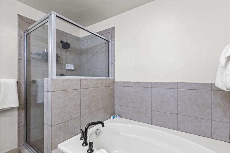 Unwind after a day of exploring in your private bathroom, featuring both a soothing soaking tub and a spacious walk-in shower.