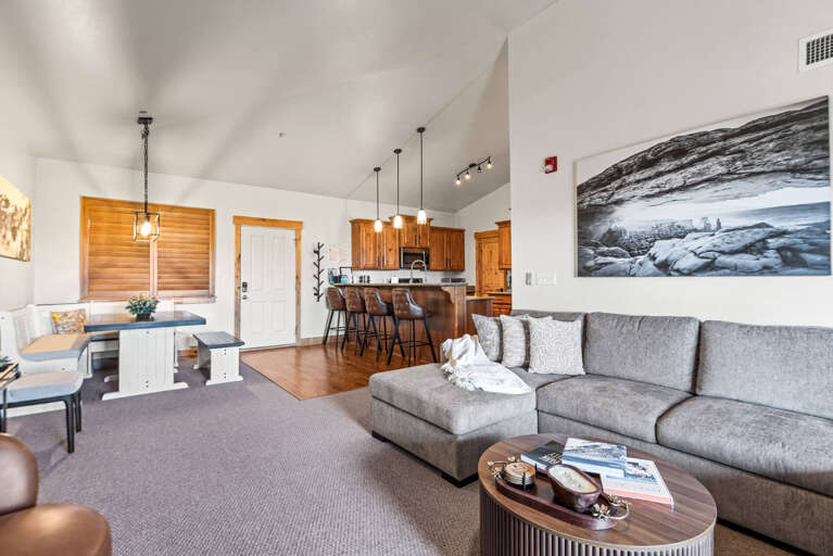 Step into a bright, open living space where comfort meets style. Sink into the cozy sectional, cook up a feast in your fully-equipped kitchen, and unwind beneath soaring vaulted ceilings that make every moment feel spacious and relaxed.