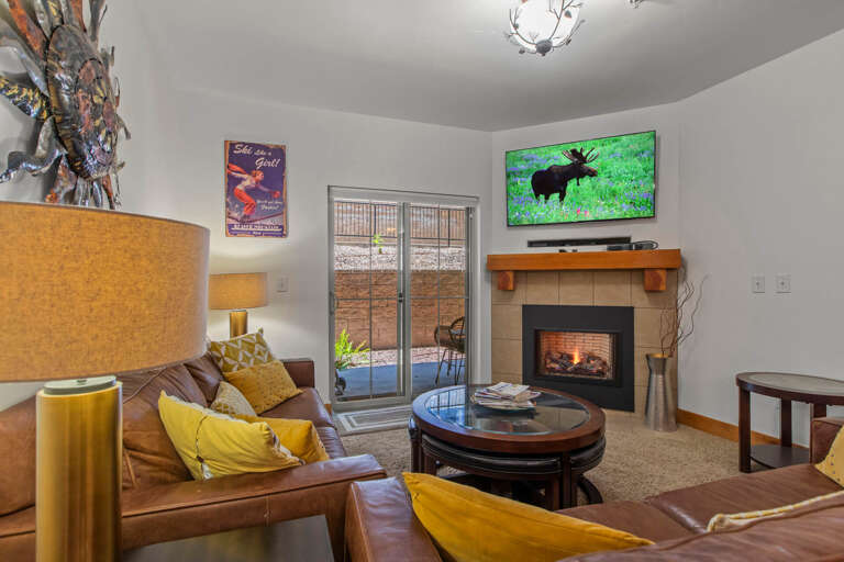 Vacation Rentals in Park City at Bear Hollow Lodges 4205 Living room with gas fireplace and patio access