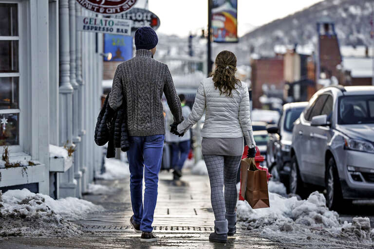 A charming winter street scene showcasing the local neighborhood and nearby shops, with snowy sidewalks inviting leisurely exploration of this mountain town's boutiques and cafés.