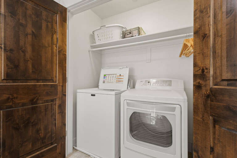 Your private laundry nook makes it easy to freshen up between adventures, with a full-size washer and dryer tucked neatly behind rustic wood doors for effortless convenience during your stay.