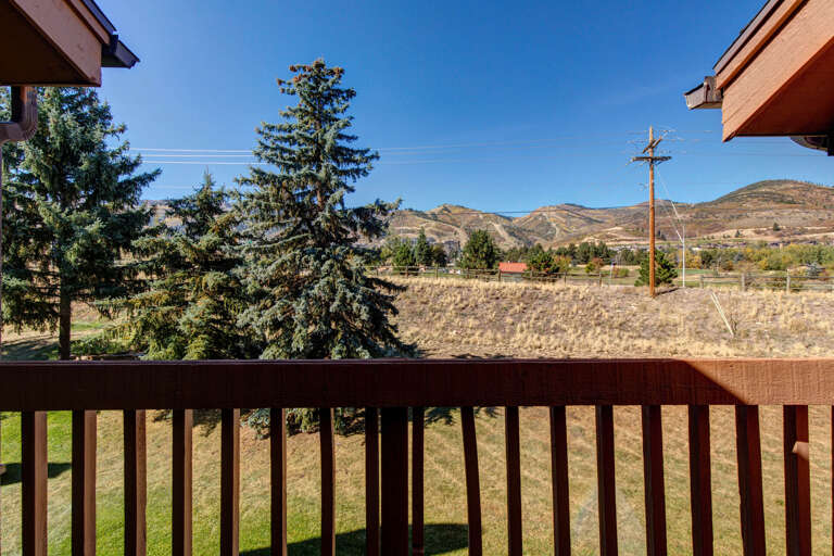 Mountain views frame this peaceful rural setting, with rolling hills and evergreens visible from the property's surrounding area.