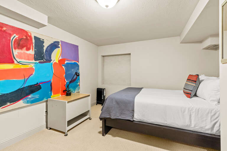 Sink into crisp white linens in your tranquil bedroom, accented by vibrant abstract art that brings personality to your restful sanctuary. This cozy space offers the perfect retreat after exploring.