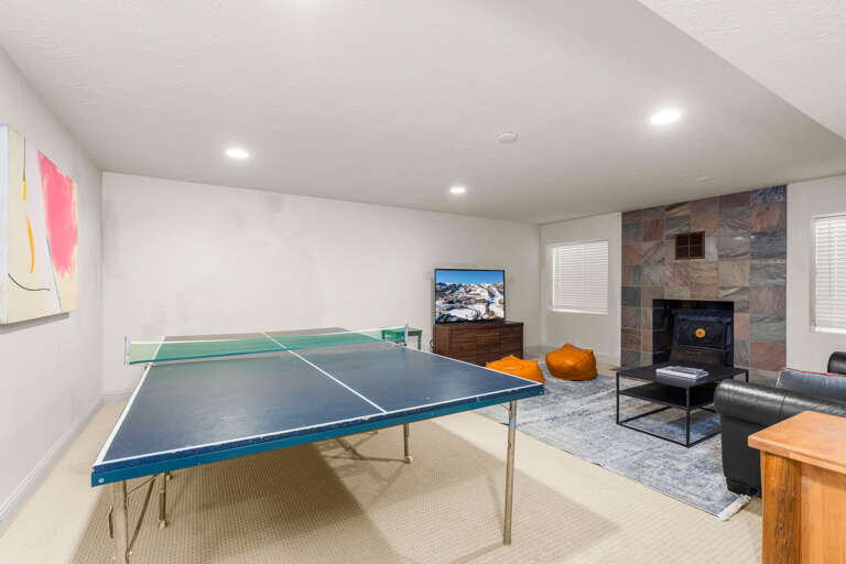 Challenge your crew to a friendly game of ping pong in your private recreation space, complete with cozy lounge seating and a warm fireplace for post-game relaxation.