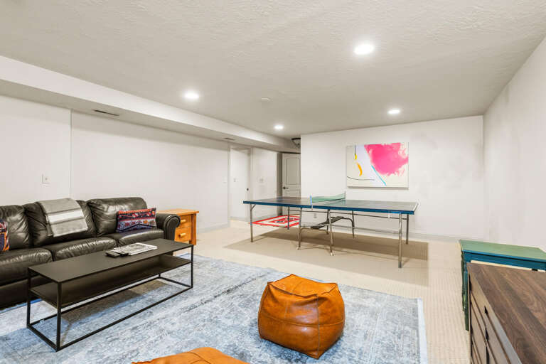 Your private game room awaits with plush seating, ping pong, and vibrant art—perfect for friendly competition and unwinding after exploring.