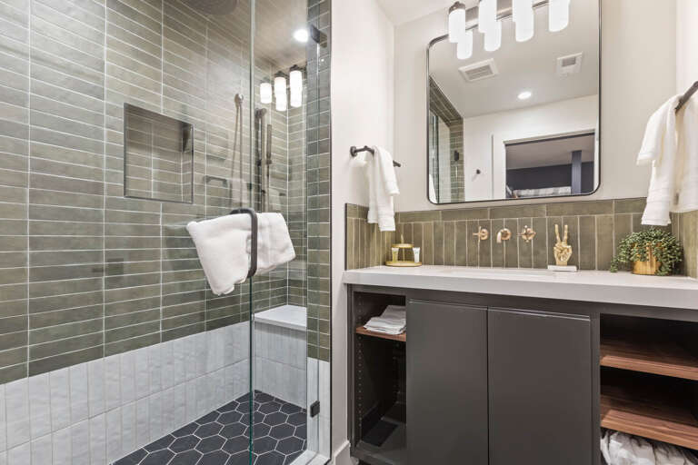 Bathroom: Sleek sink and modern shower area.