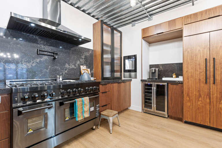 Kitchen: Sleek gas range, countertops, and deep sink.
