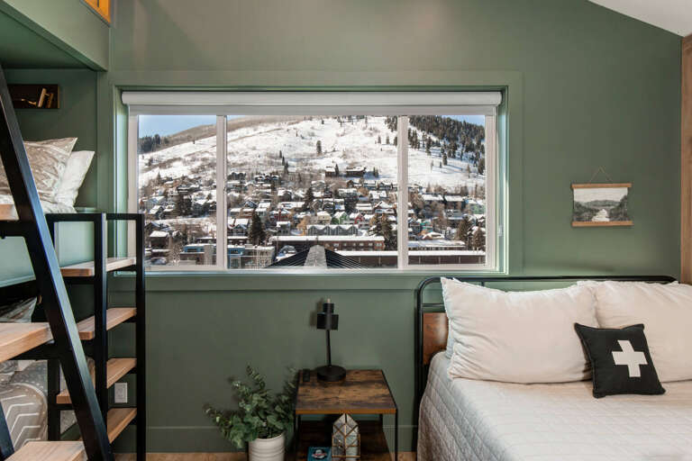 Queen Bed, Overhead Window Triple Bunk Bed: Cozy sleeping with a view