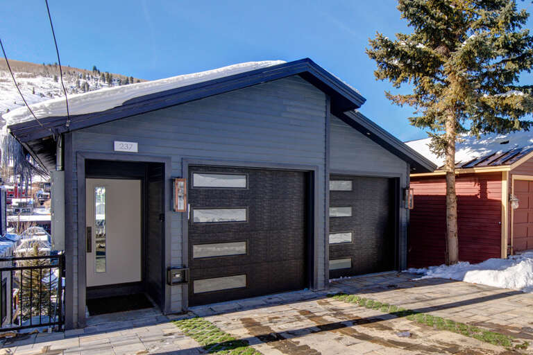 Modern mountain retreat with contemporary design and direct slope access. Snow-dusted peaks frame this alpine property, steps from ski-in convenience and village amenities.