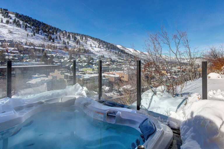 Property sits in a scenic mountain valley, surrounded by snow-covered peaks and evergreens. A winter wonderland escape in a charming alpine community.
