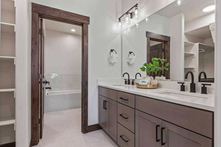 Step into your beautifully designed bathroom with a spacious vanity, modern fixtures, and warm wood accents—your personal spa retreat awaits after a long day of exploring.