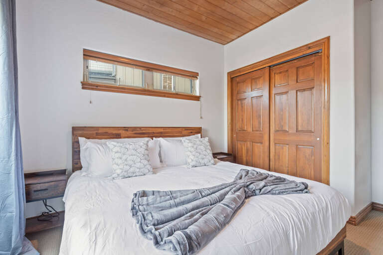 Bear Hollow 5482:  Cozy bed with fluffy pillows in a serene setting.