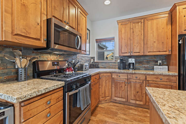 Bear Hollow 5482: "Sleek countertops, modern range, coffee maker, and microwave in this kitchen.