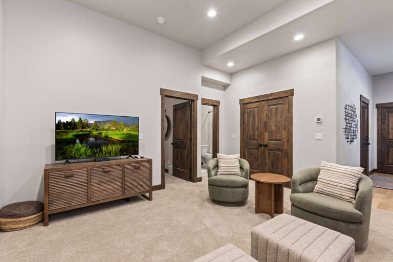 Unwind in your cozy living room, where plush seating and warm wood tones create the perfect spot to relax after a day of adventure.