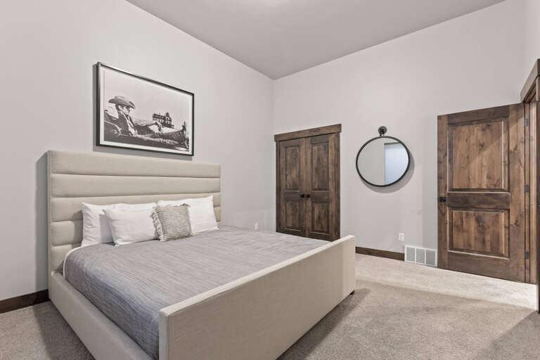 Slip into peaceful rest in your private bedroom, complete with a plush upholstered bed, rustic wood details, and warm neutral tones that invite relaxation.