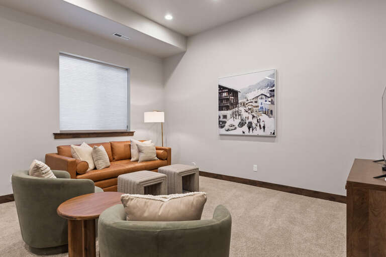 Settle into your private living room with soft seating, warm textures, and charming alpine artwork—perfect for unwinding after a day of adventure.