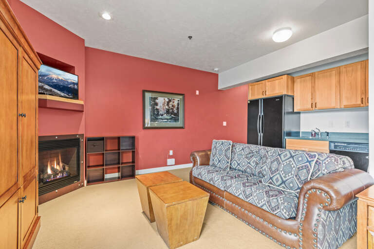 Stillwater Lodge 3005: Cozy ambiance with a sofa set, center table, and fireplace." Stillwater Lodge 3005: Cozy ambiance with a sofa set, center table, and fireplace."