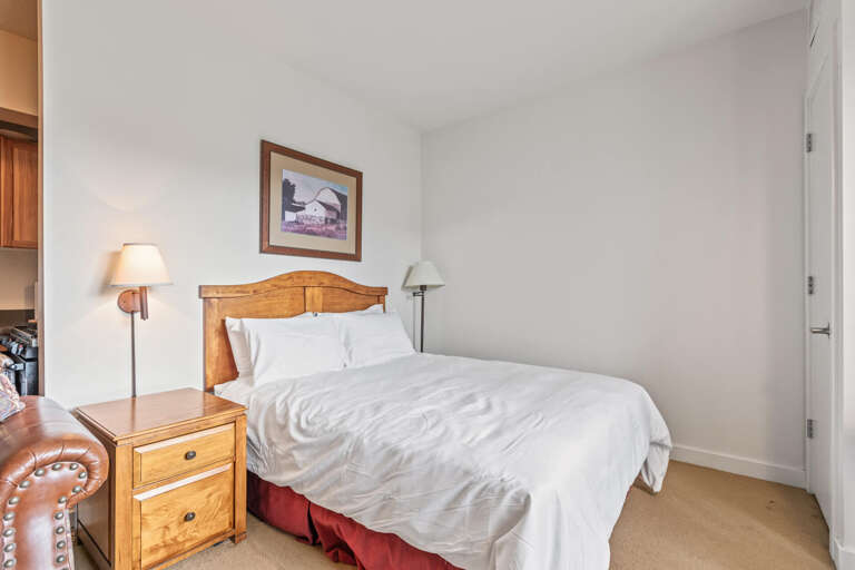 Stillwater Lodge 3005: Cozy bed with elegant lampshade, perfect for a peaceful night's sleep. Stillwater Lodge 3005: Cozy bed with elegant lampshade, perfect for a peaceful night's sleep.