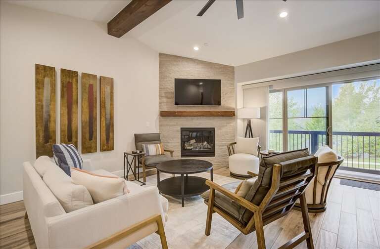 Black Rock Ridge 14202: Living Room: "Cozy corner with fireplace, TV, and balcony view through sliding door." Black Rock Ridge 14202: Living Room: "Cozy corner with fireplace, TV, and balcony view through sliding door."