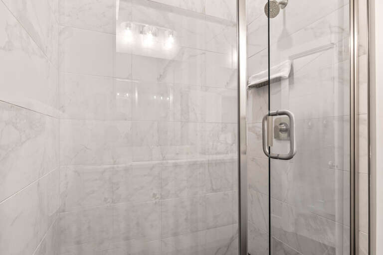 Mayflower Lakeside 301-45: Modern shower with sleek glass enclosure, a perfect oasis for relaxation.