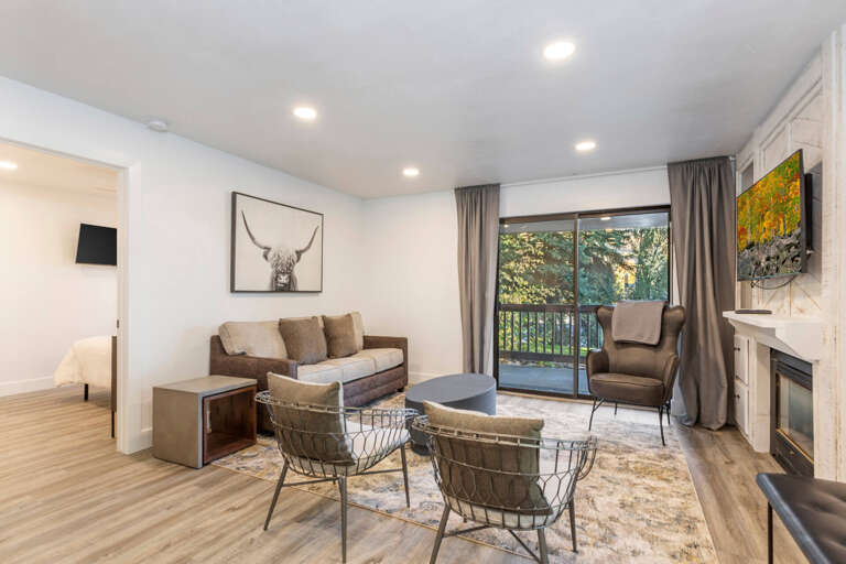 Cozy seating by fireplace, perfect for relaxing near outdoor patio. Cozy seating by fireplace, perfect for relaxing near outdoor patio.