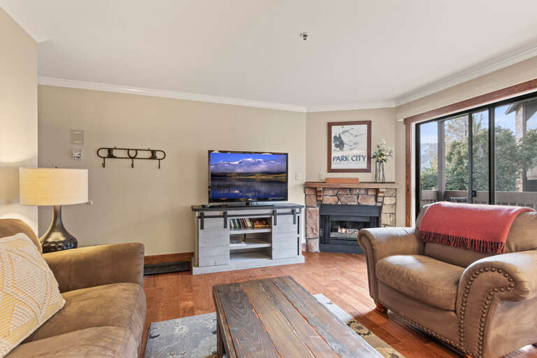 Powderwood 11C: Cozy setup with a sofa set, center table, and a fireplace Powderwood 11C: Cozy setup with a sofa set, center table, and a fireplace