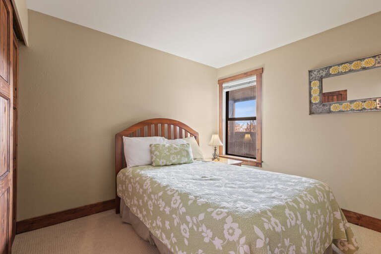 Powderwood 11C: Sunlight streaming through window, casting a warm glow on the bed. Powderwood 11C: Sunlight streaming through window, casting a warm glow on the bed.