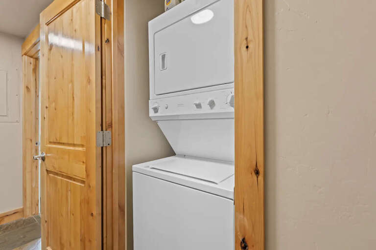 Your laundry needs are covered with this convenient stacked washer and dryer, tucked neatly behind natural wood doors for easy access during your stay.