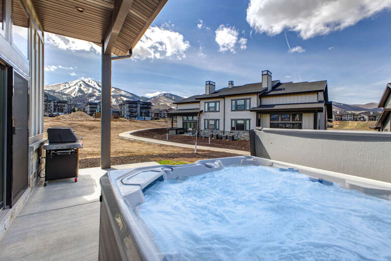 Soak in your private hot tub under open skies, with stunning mountain views creating the perfect backdrop for relaxation after a day of adventure.