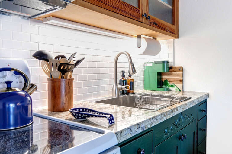 Cozy kitchen with coffee maker and electric range for culinary adventures. Cozy kitchen with coffee maker and electric range for culinary adventures.
