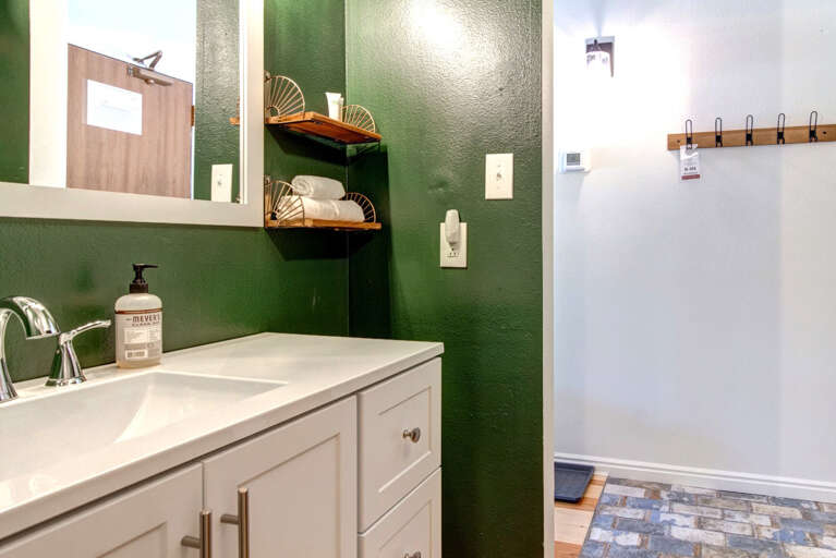 Sleek sink and mirror in a spacious, full bathroom oasis. Sleek sink and mirror in a spacious, full bathroom oasis.
