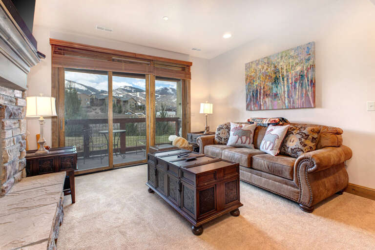 Settle into your cozy living space with mountain views framing every moment. Warm leather seating and rustic charm create the perfect retreat after a day of adventure.