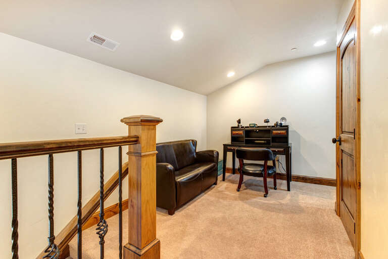 A quiet upstairs nook offers your own workspace with a stylish desk and comfortable leather loveseat—perfect for catching up on emails or enjoying a good book.